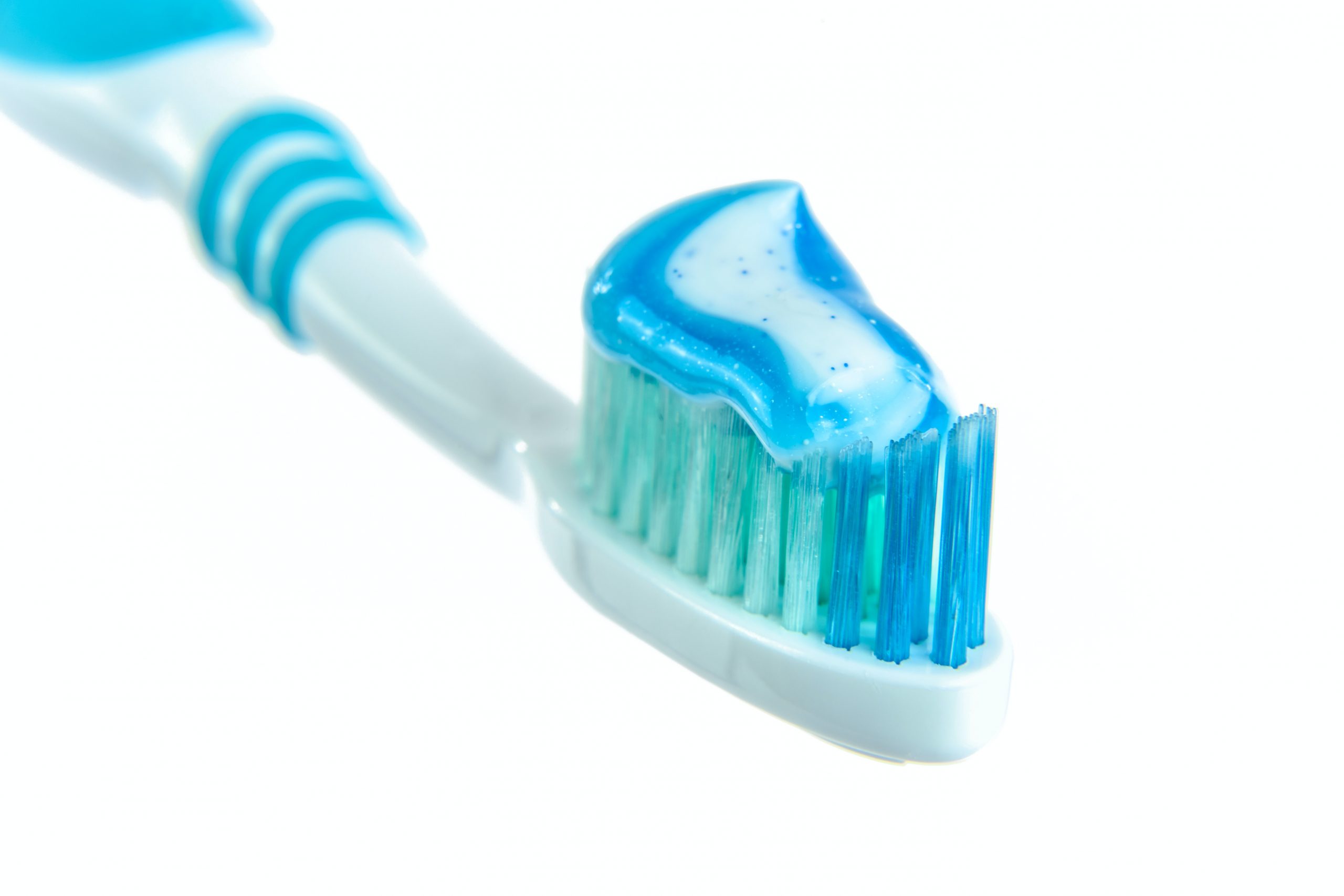 blue-and-white-toothpaste-on-toothbrush-216729
